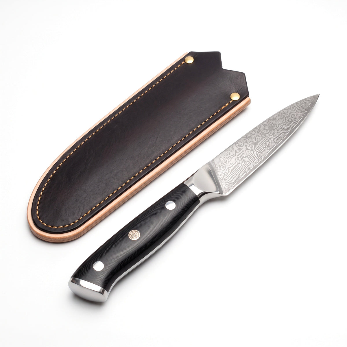 3.5" Damascus Paring Knife | Black Micarta, three-quarter view with the Crownridge blade guard