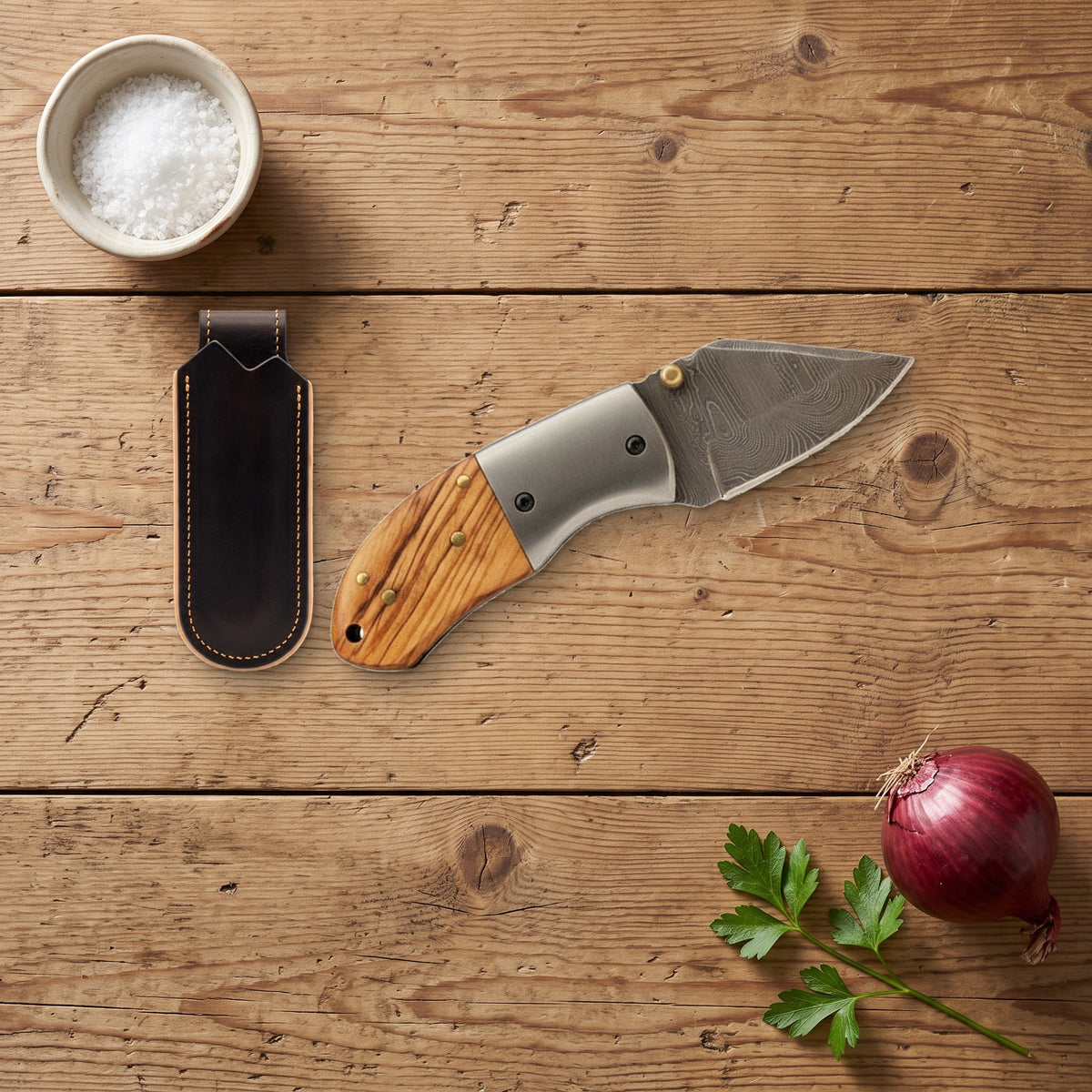 Creek 5" Damascus Pocket Knife | Olive Wood, with the Crownridge belt slip in use