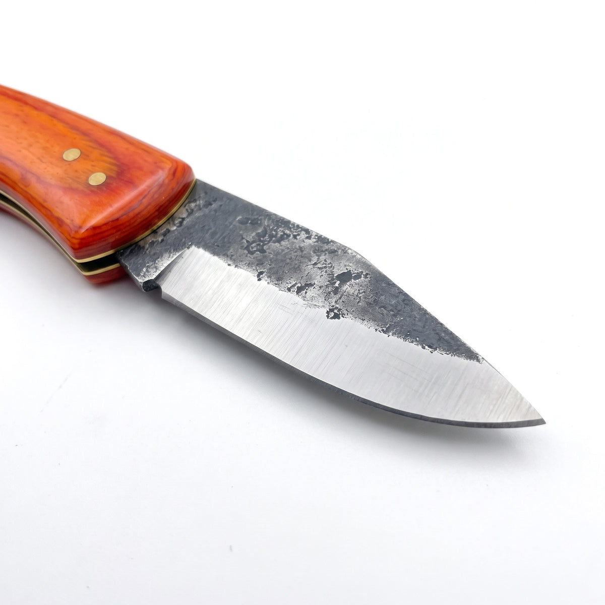 Creek 6.4" Carbon Steel Pocket Knife | Orange Resin, carbon steel blade close-up