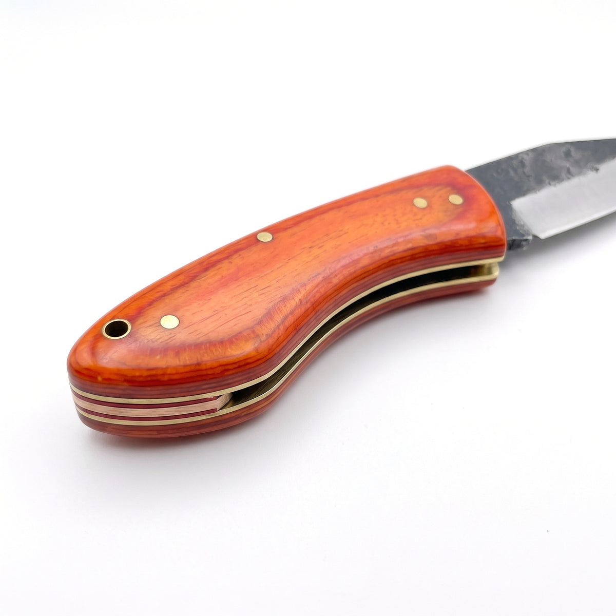 Creek 6.4" Carbon Steel Pocket Knife | Orange Resin, handle and fittings close-up