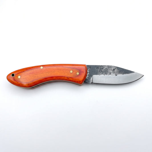 Creek 6.4" Carbon Steel Pocket Knife | Orange Resin, side profile on white