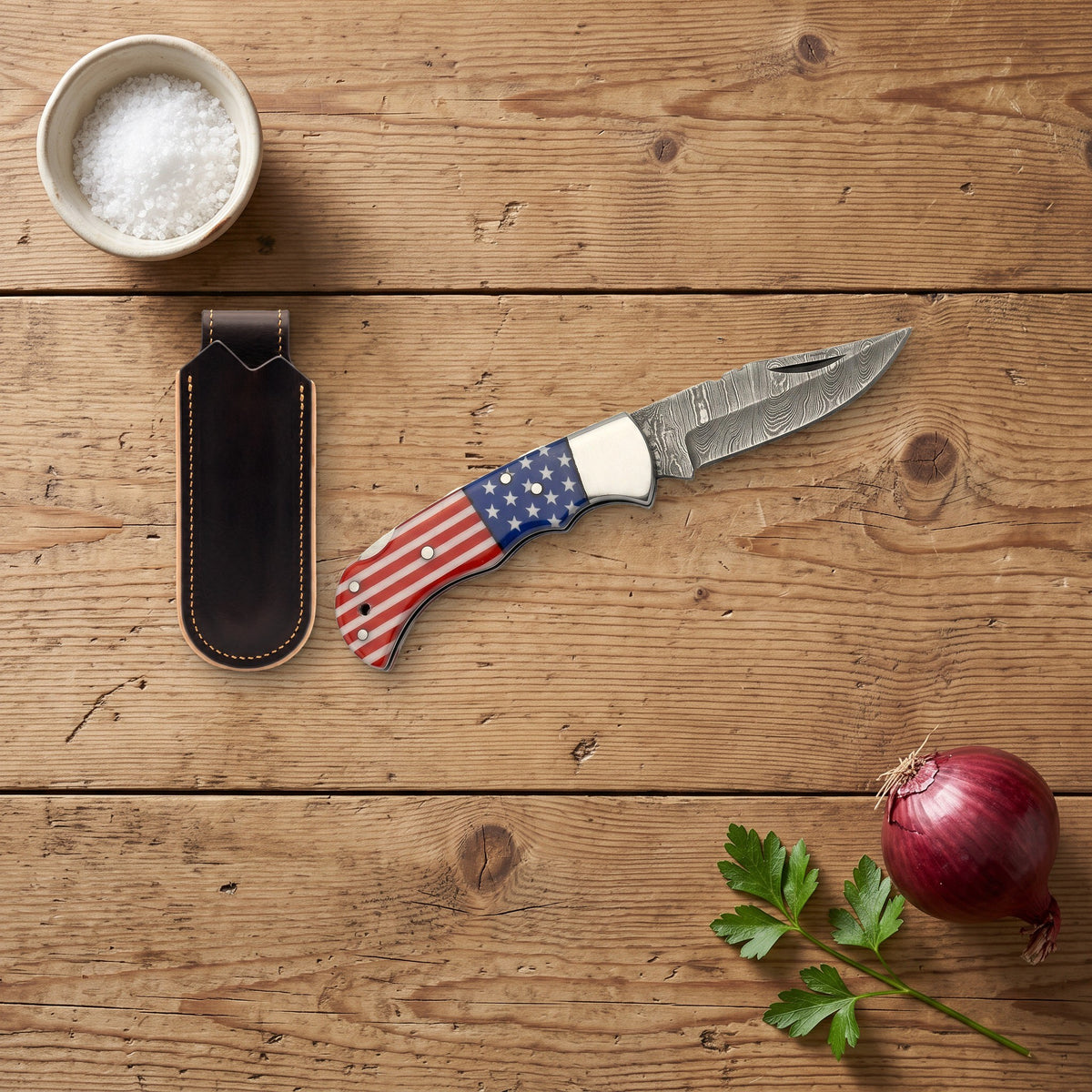 Creek 6.5" Damascus Pocket Knife | Flag Resin, with the Crownridge belt slip in use