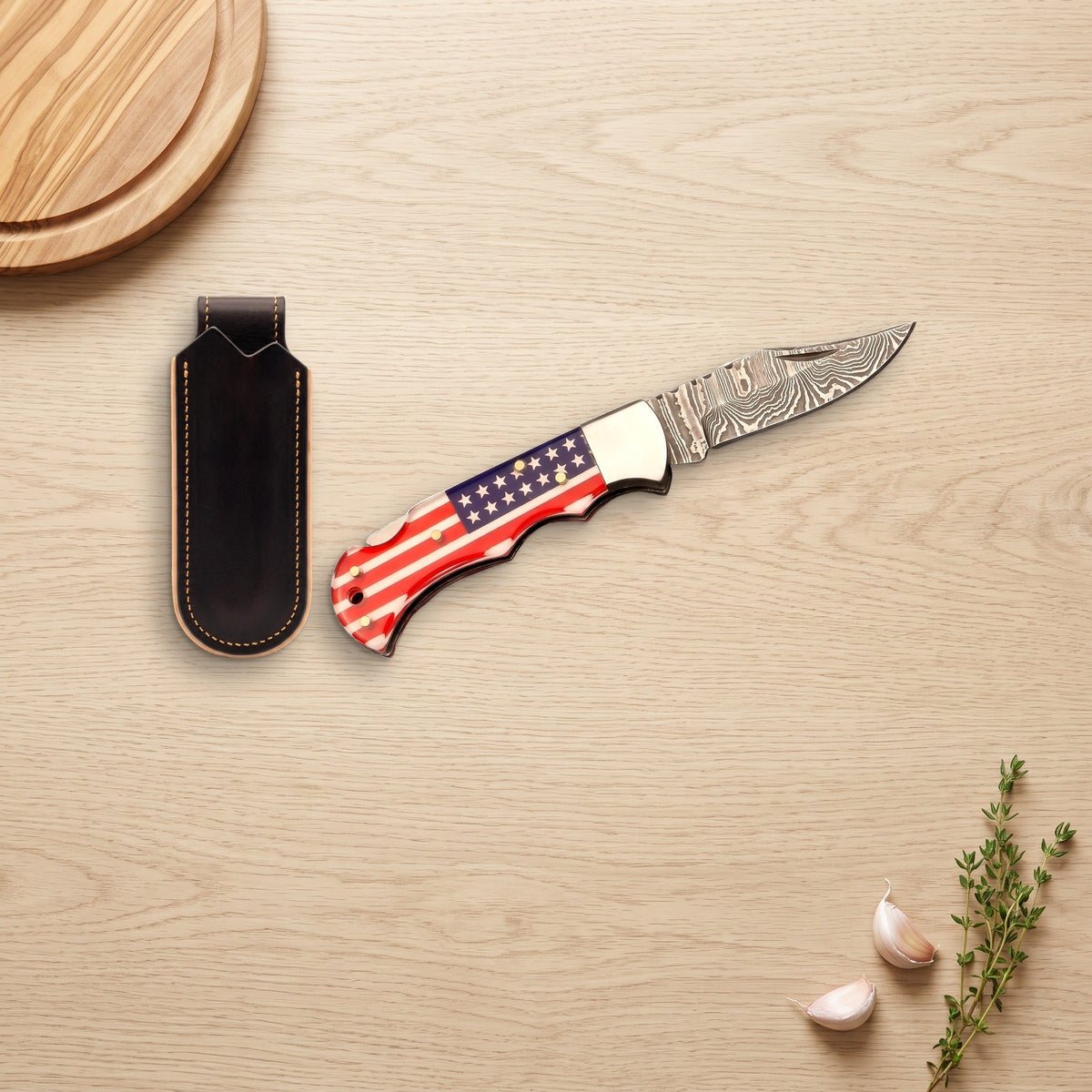 Creek 6.8" Damascus Pocket Knife | Flag Resin, with the Crownridge belt slip in use