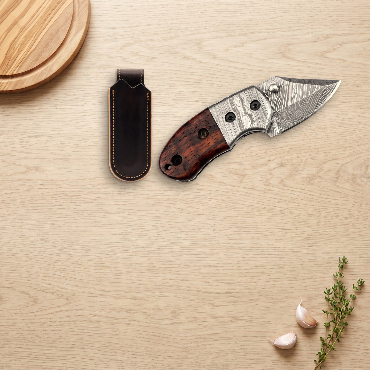 Creek 6" Damascus Pocket Knife | Rosewood, with the Crownridge belt slip in use