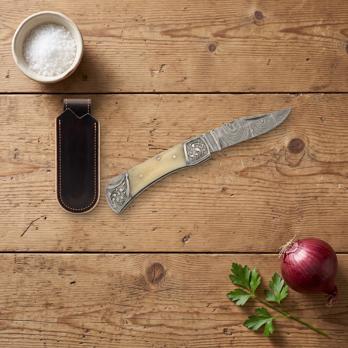 Creek 7.5" Damascus Pocket Knife | Bone, with the Crownridge belt slip in use