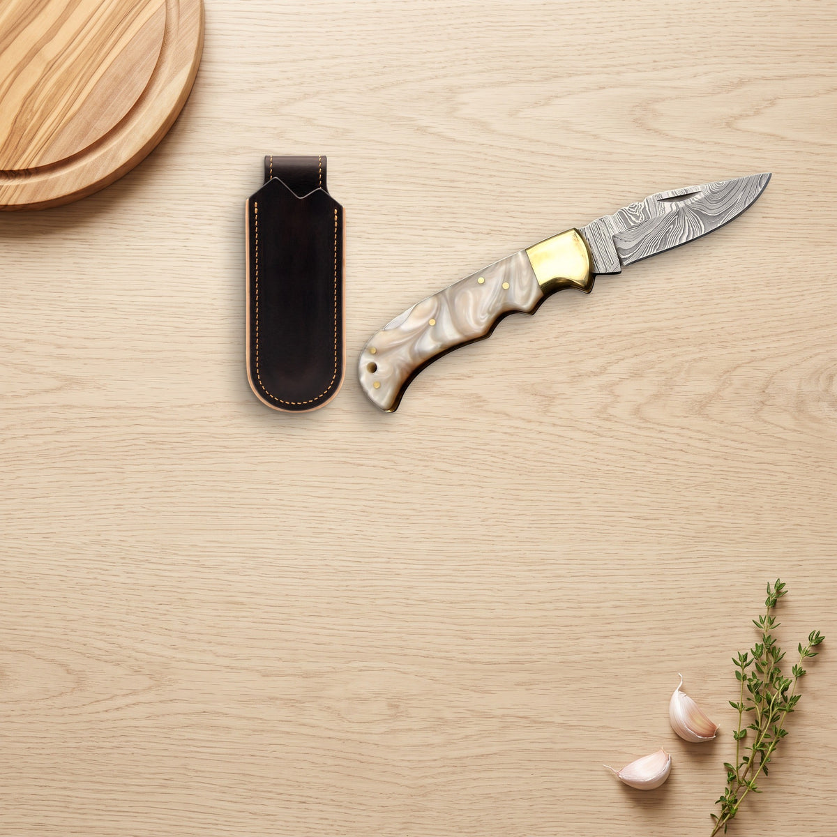 Creek 7.5" Damascus Pocket Knife | Mother of Pearl, with the Crownridge belt slip in use