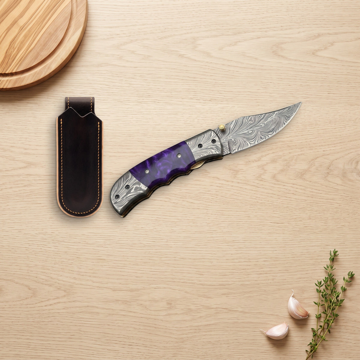 Creek 7.5" Damascus Pocket Knife | Resin, with the Crownridge belt slip in use