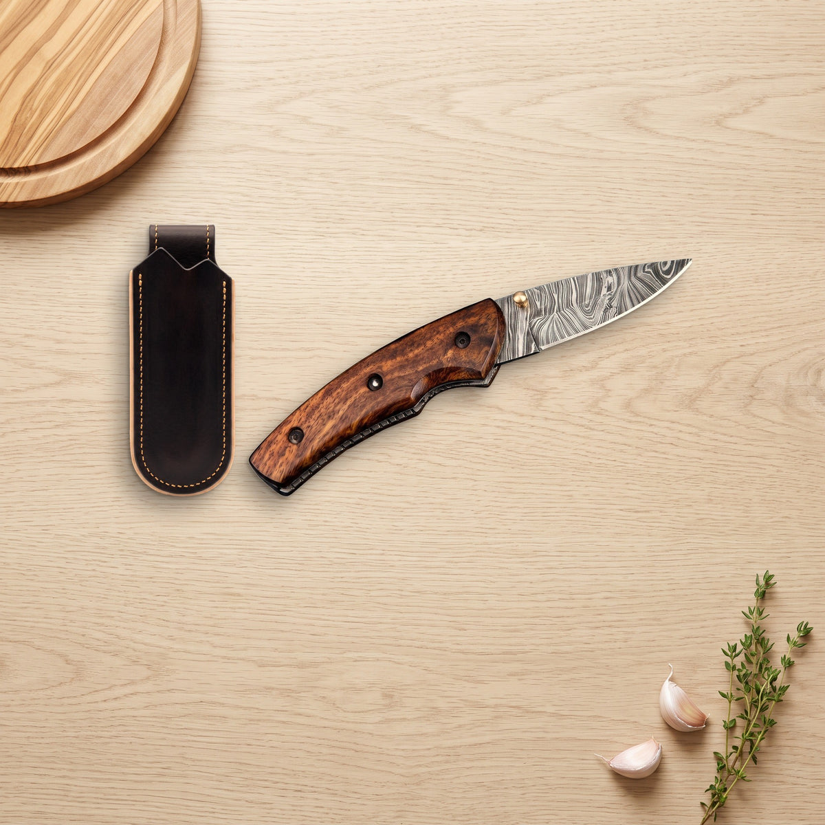 Creek 7.5" Damascus Pocket Knife | Tali Wood, with the Crownridge belt slip in use