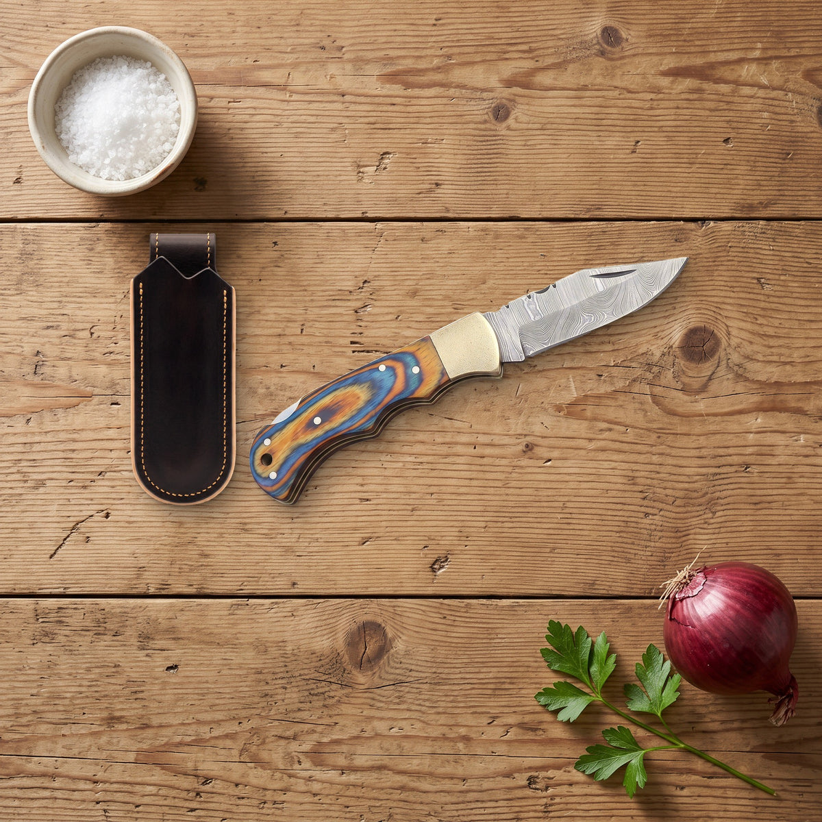 Creek 7" Damascus Pocket Knife | Dyed Wood, with the Crownridge belt slip in use