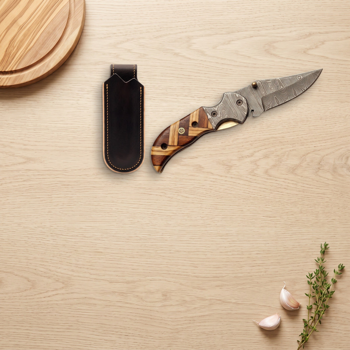 Creek 7" Damascus Pocket Knife | Olive Wood, with the Crownridge belt slip in use