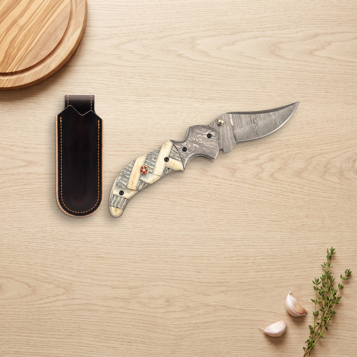 Creek 7" Damascus Pocket Knife | Ram Horn, with the Crownridge belt slip in use