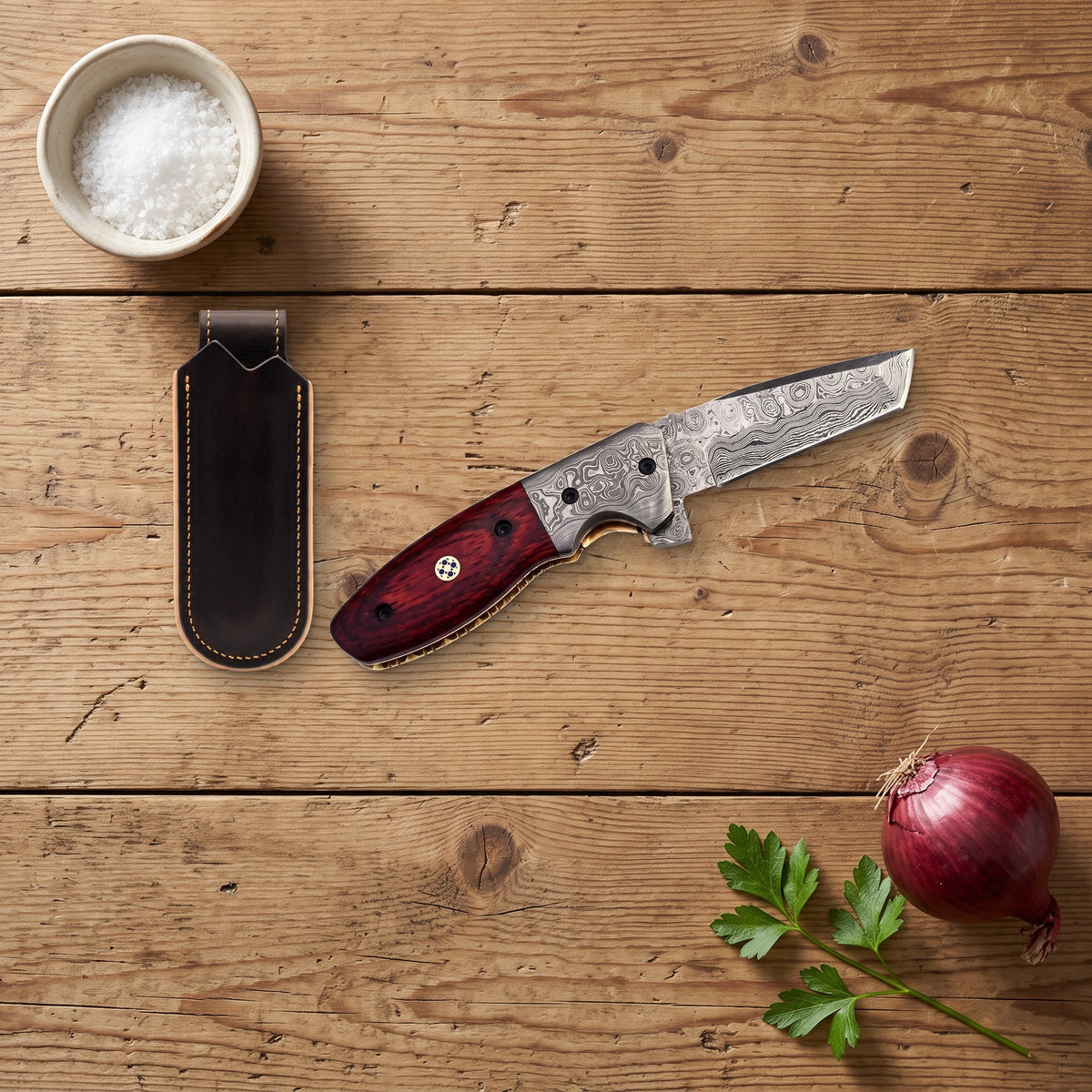 Creek 7" Damascus Pocket Knife | Snakewood, with the Crownridge belt slip in use