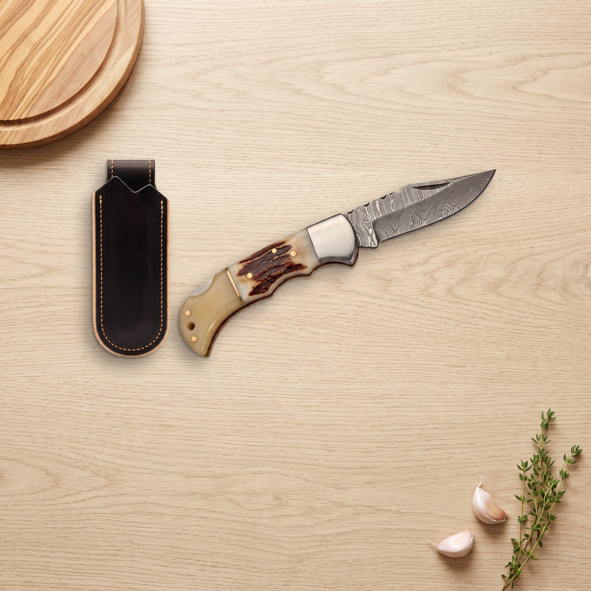 Creek 7" Damascus Pocket Knife | Stag, with the Crownridge belt slip in use