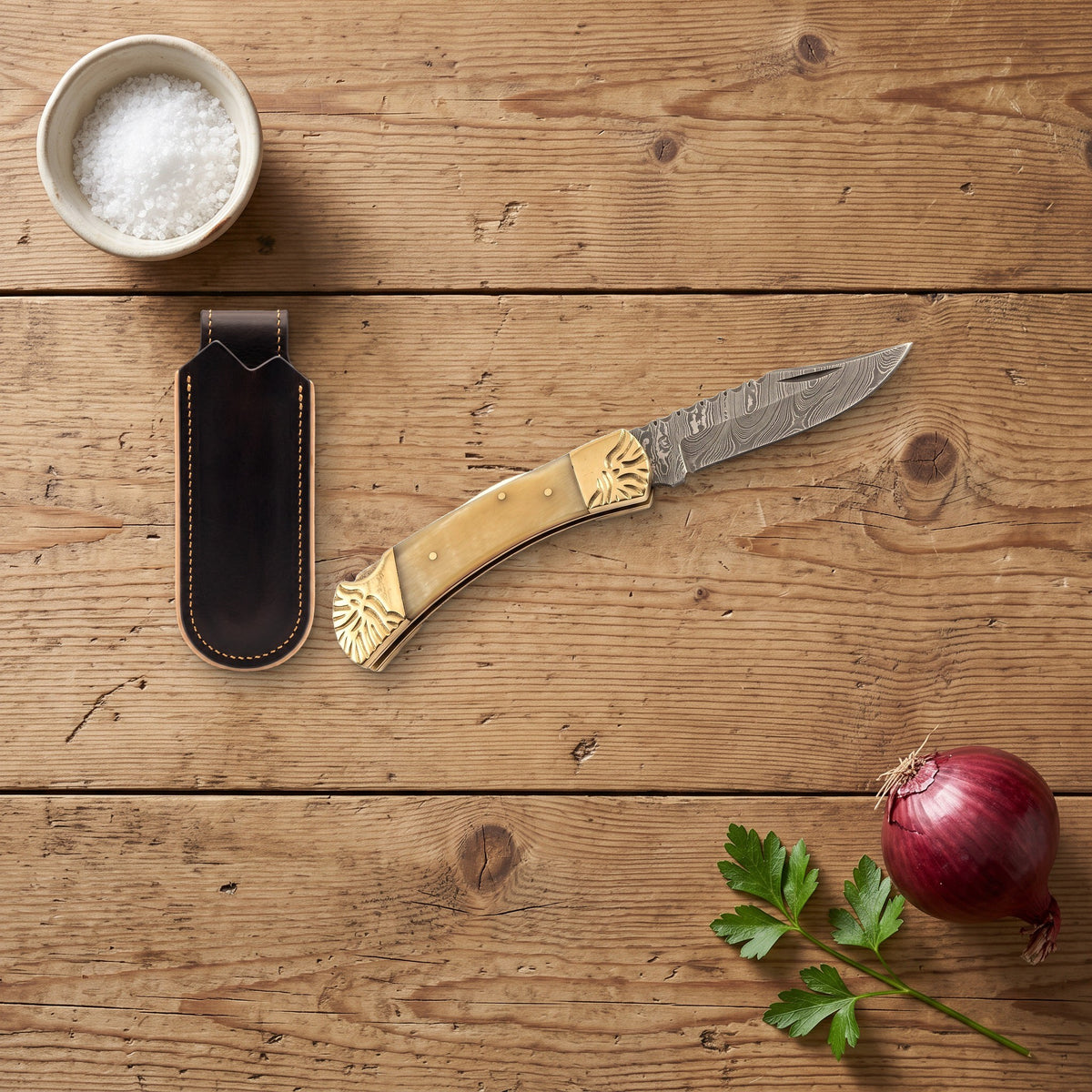 Creek 8.5" Damascus Pocket Knife | Bone & Brass, with the Crownridge belt slip in use