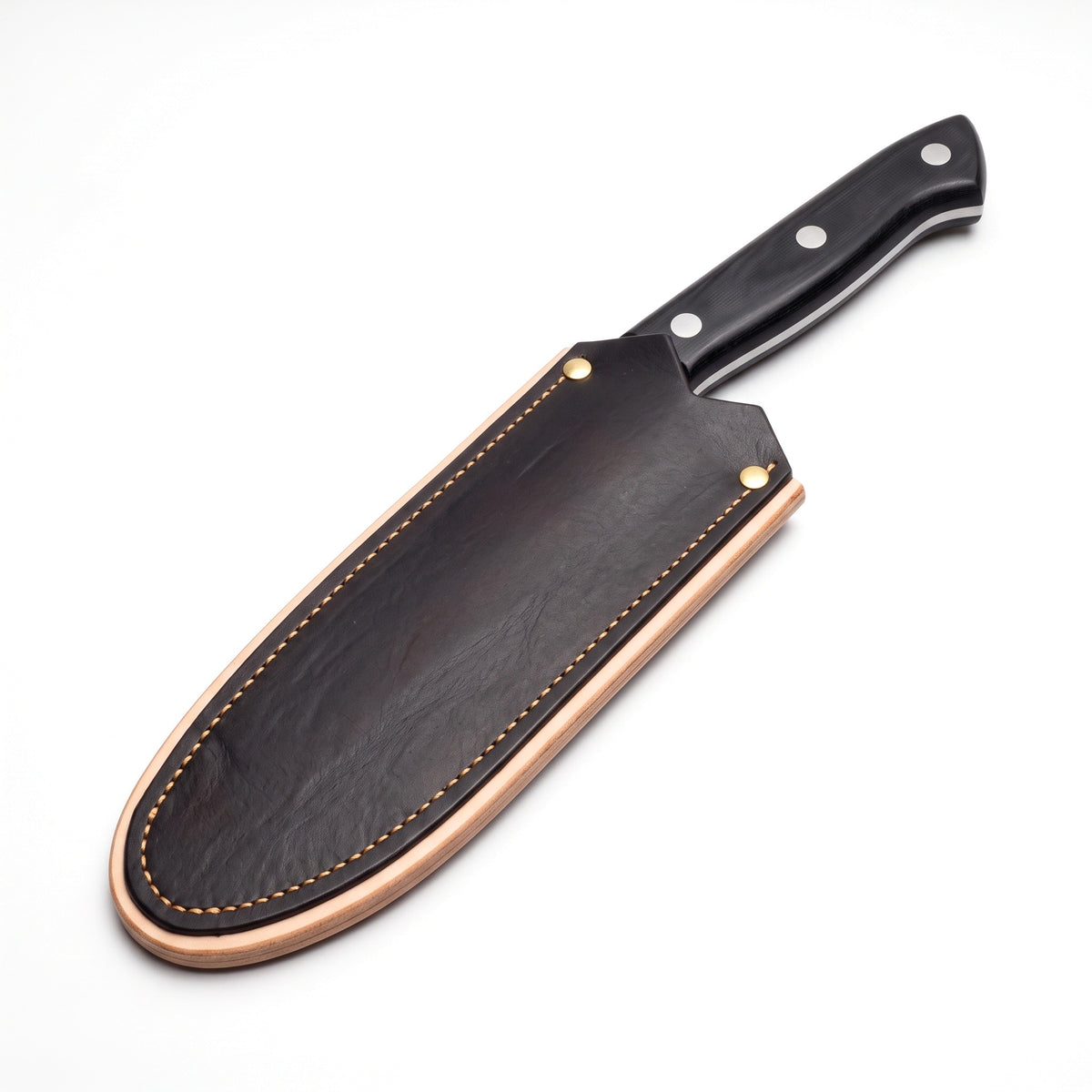 Hollow 7" Carbon Steel Serbian Chef Knife | Black Micarta, seated in the Crownridge blade guard