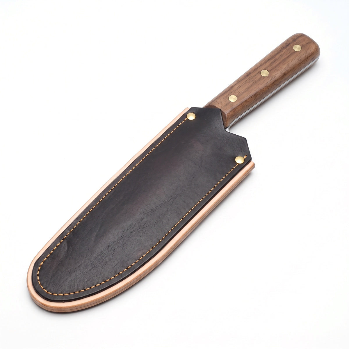 Hollow 7" Carbon Steel Serbian Chef Knife | Walnut, seated in the Crownridge blade guard