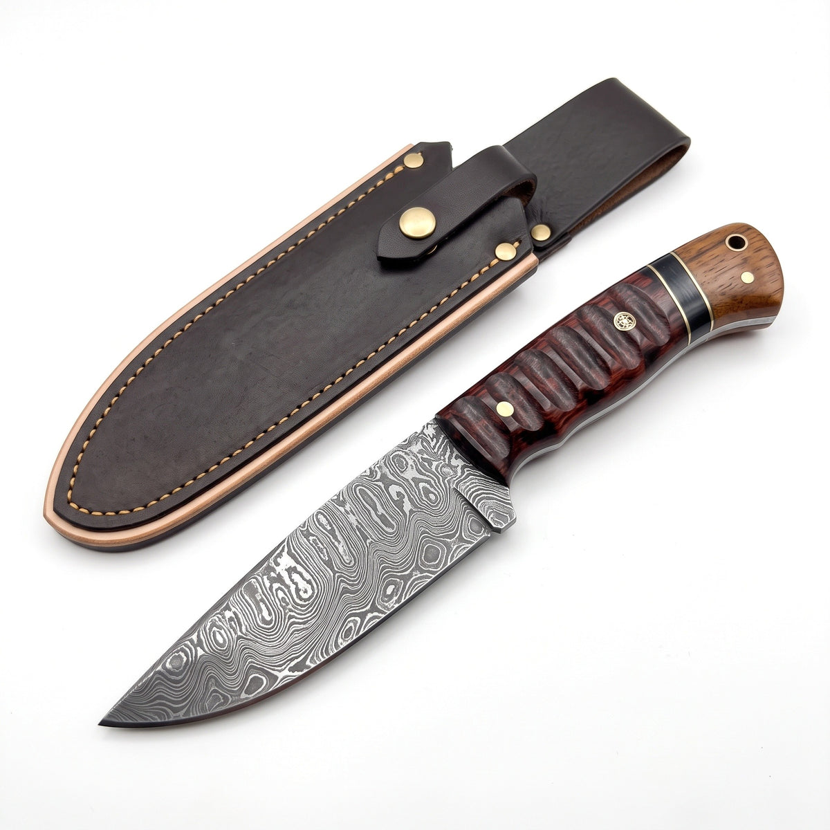 Ridgeback 9.5" Damascus Hunting Knife | Walnut & Brass, three-quarter view with the Crownridge sheath