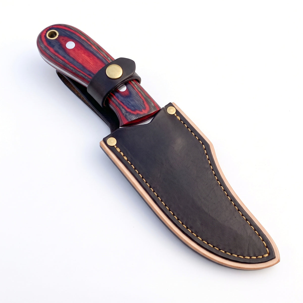 Trailhead 7" Carbon Steel Skinning Knife | Red Dyed Wood, seated in the Crownridge sheath